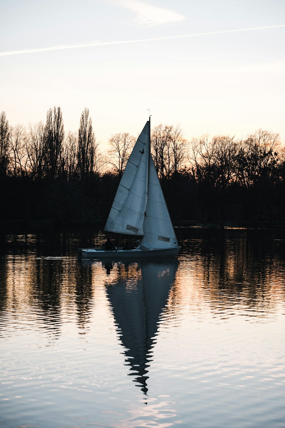 white sailboat on calm water during daytime