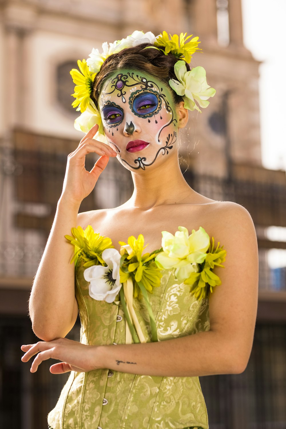 woman in yellow floral head dress with green and white flower headdress