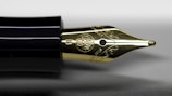 Close-up of a sleek fountain pen with Ohio Smoke Youth Football Inc logo on the barrel.