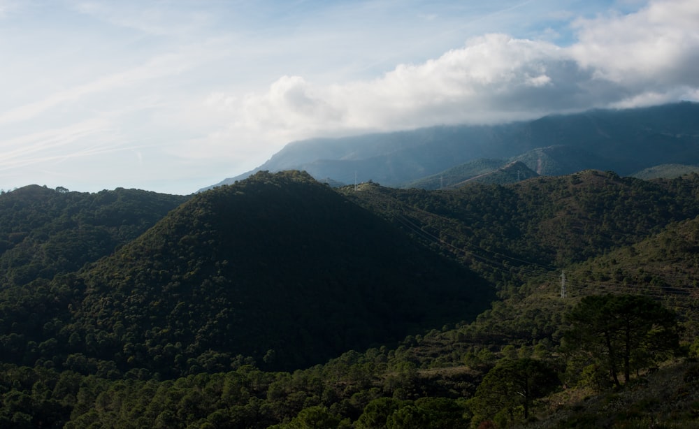 green mountains under white clouds during daytime