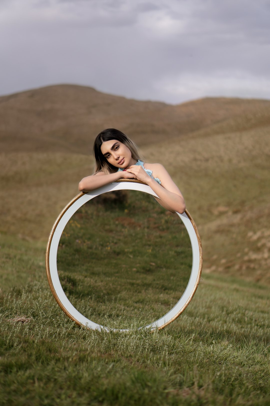 woman in white dress sitting on white round frame