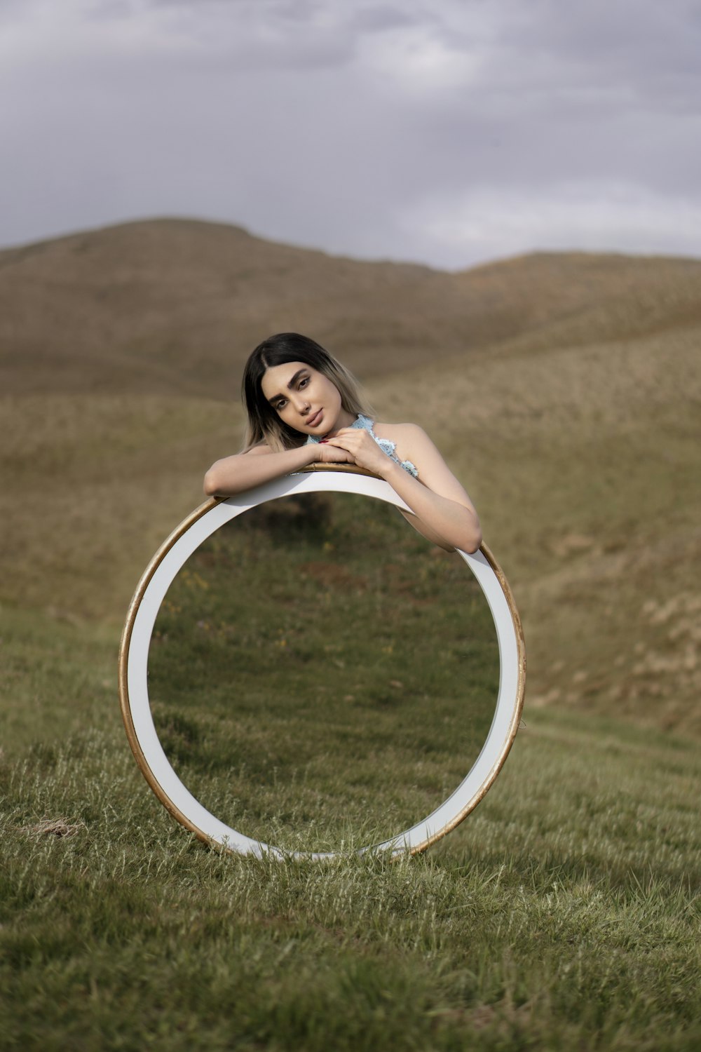 woman in white dress sitting on white round frame