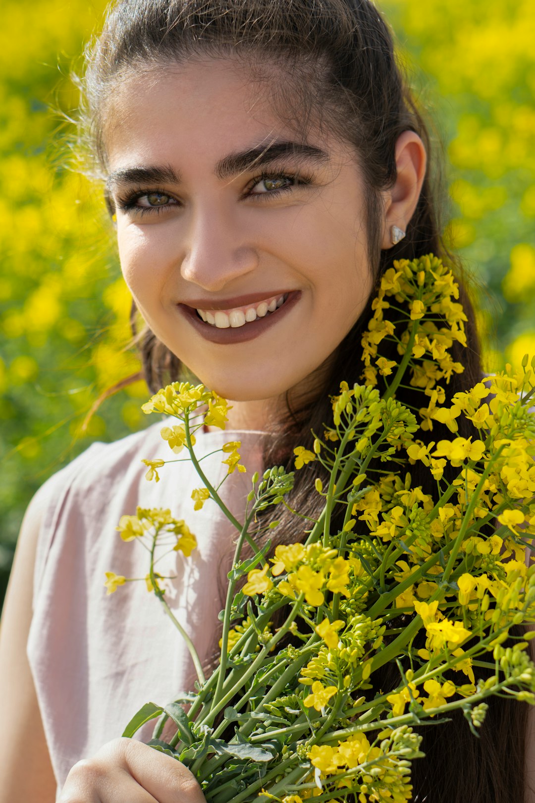 smiling woman in white shirt with yellow flowers on her head
