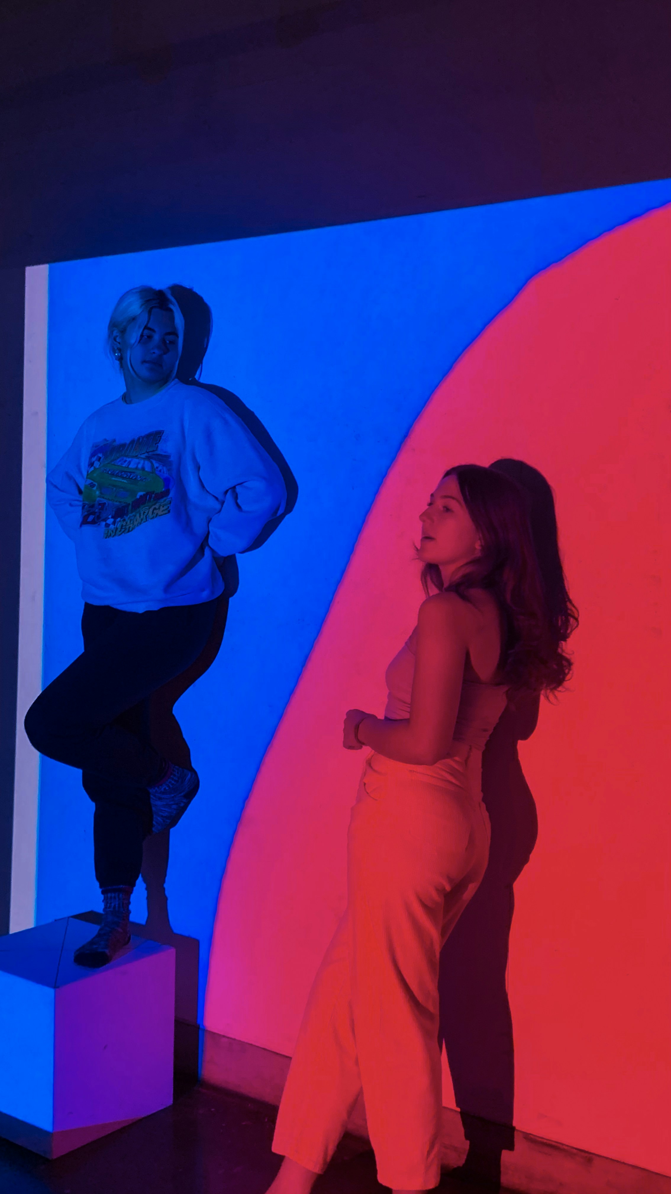 man in blue long sleeve shirt beside woman in red dress