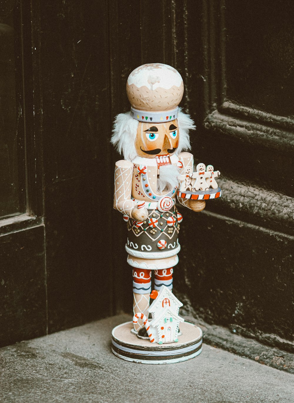 snowman figurine on black concrete floor