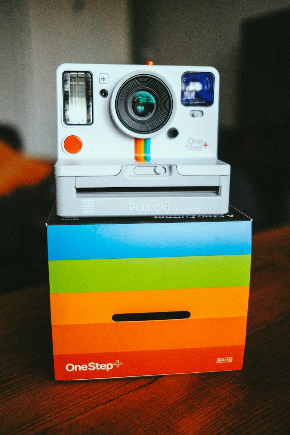 white and blue camera on yellow and blue striped box