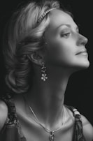 A serene portrait of a black woman adorned with ancestral jewelry, exuding quiet strength.