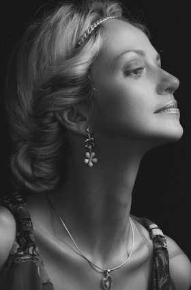 Elegant portrait of Mme Berrada in a sleek black and gold setting, embodying confidence and expertise.