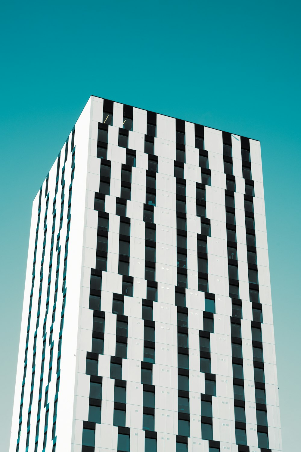 white and black concrete building under blue sky during daytime