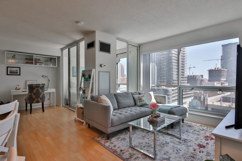 gray sofa near glass window