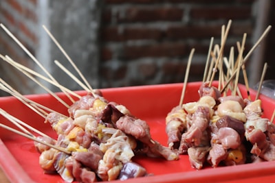 Assorted chicken offal including liver, gizzards, and hearts displayed on a wooden board.