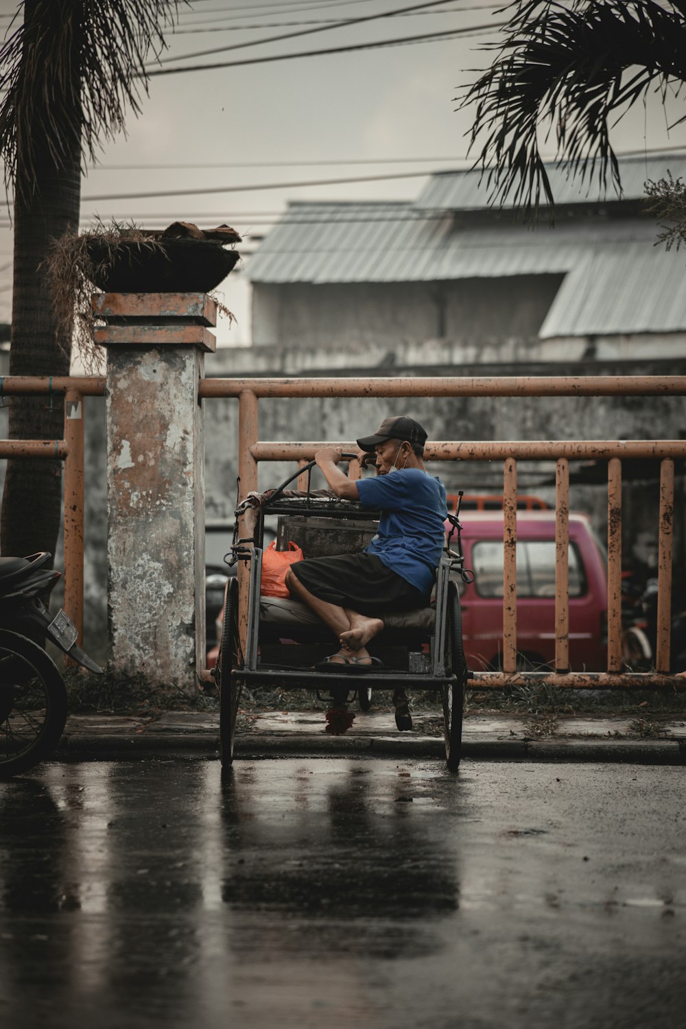 boy in blue t-shirt sitting on red wooden chair