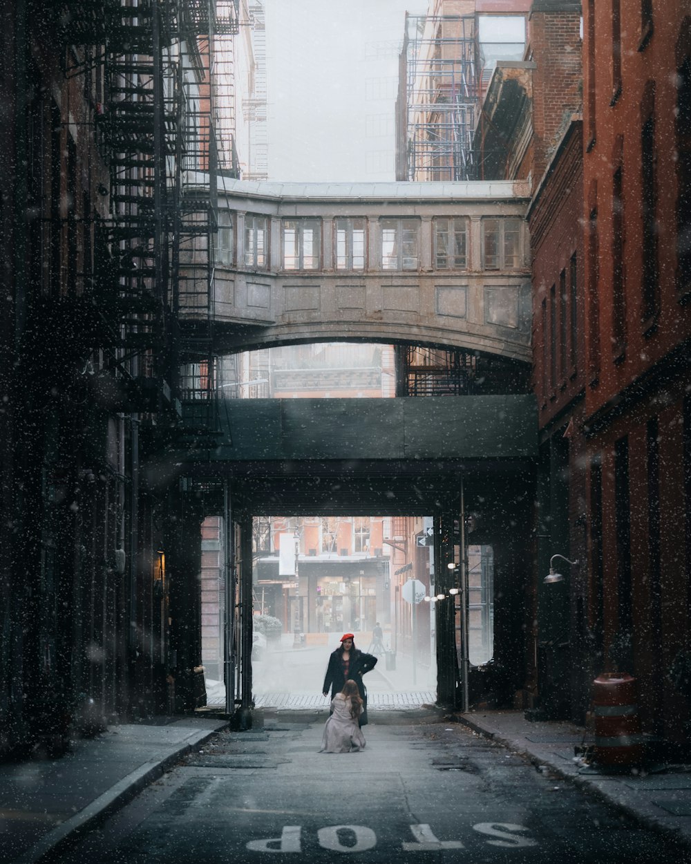 man in black jacket walking on sidewalk during daytime