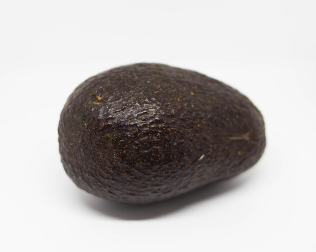 black oval fruit on white surface