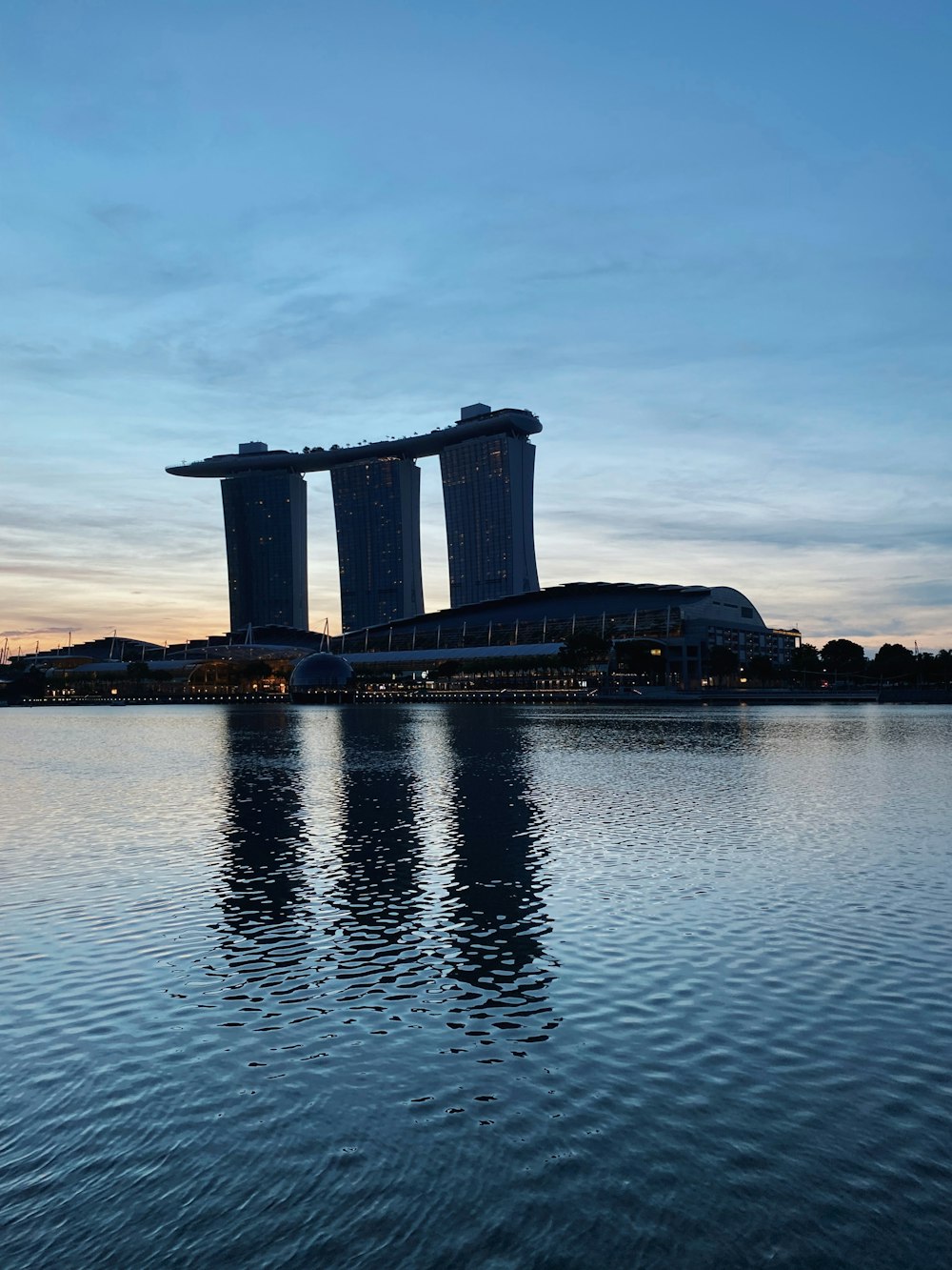 gray concrete building on body of water during daytime