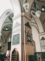 Close-up of elegant calligraphy and gold accents on the mosque’s interior walls.