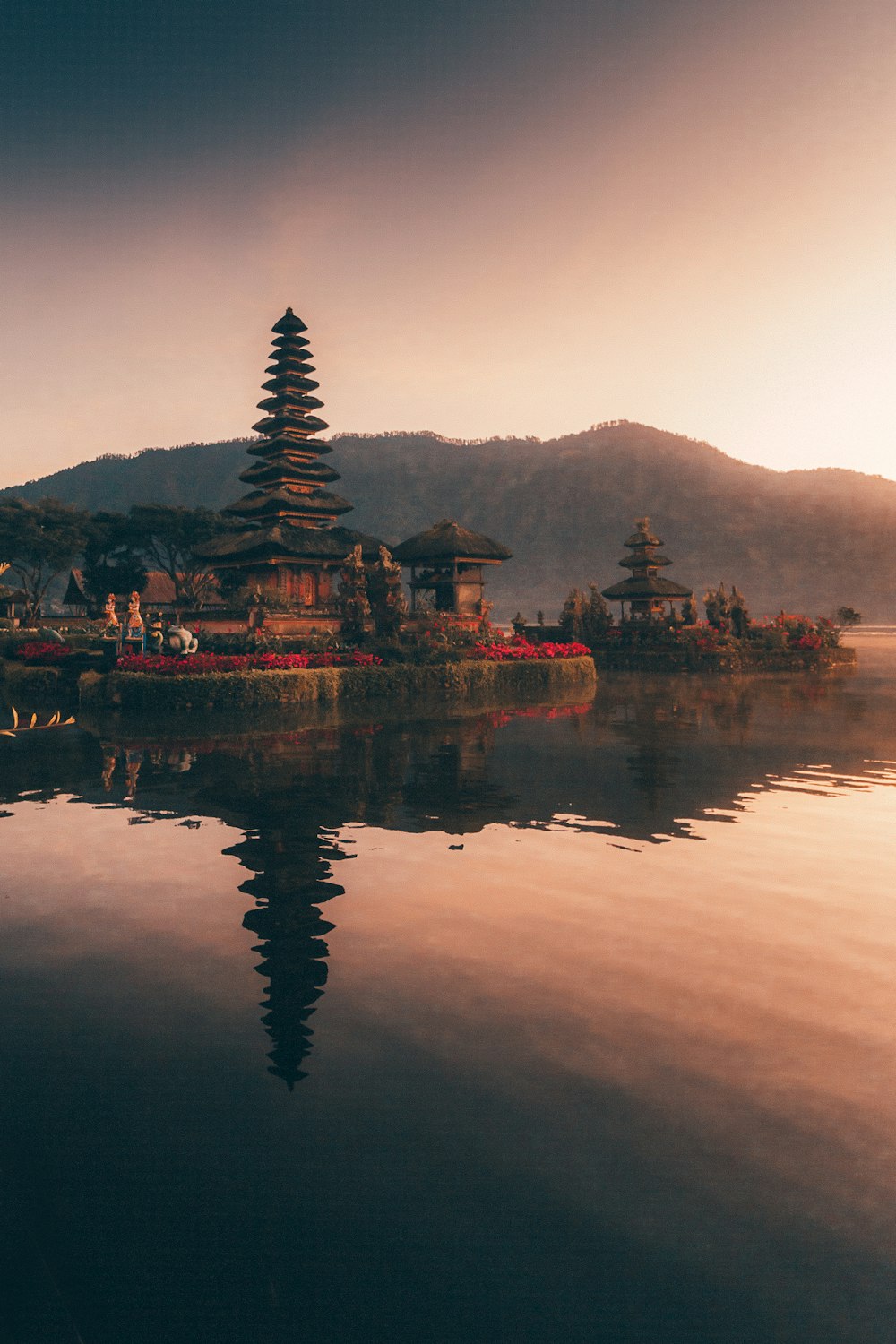 brown and black temple near body of water during daytime