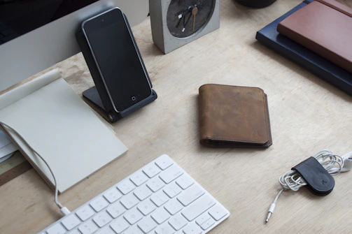 A neatly arranged desk mat with matching ergonomic wrist rests and a magnetic cable holder.