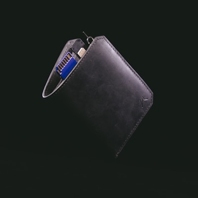 black leather bifold wallet with blue and silver key
