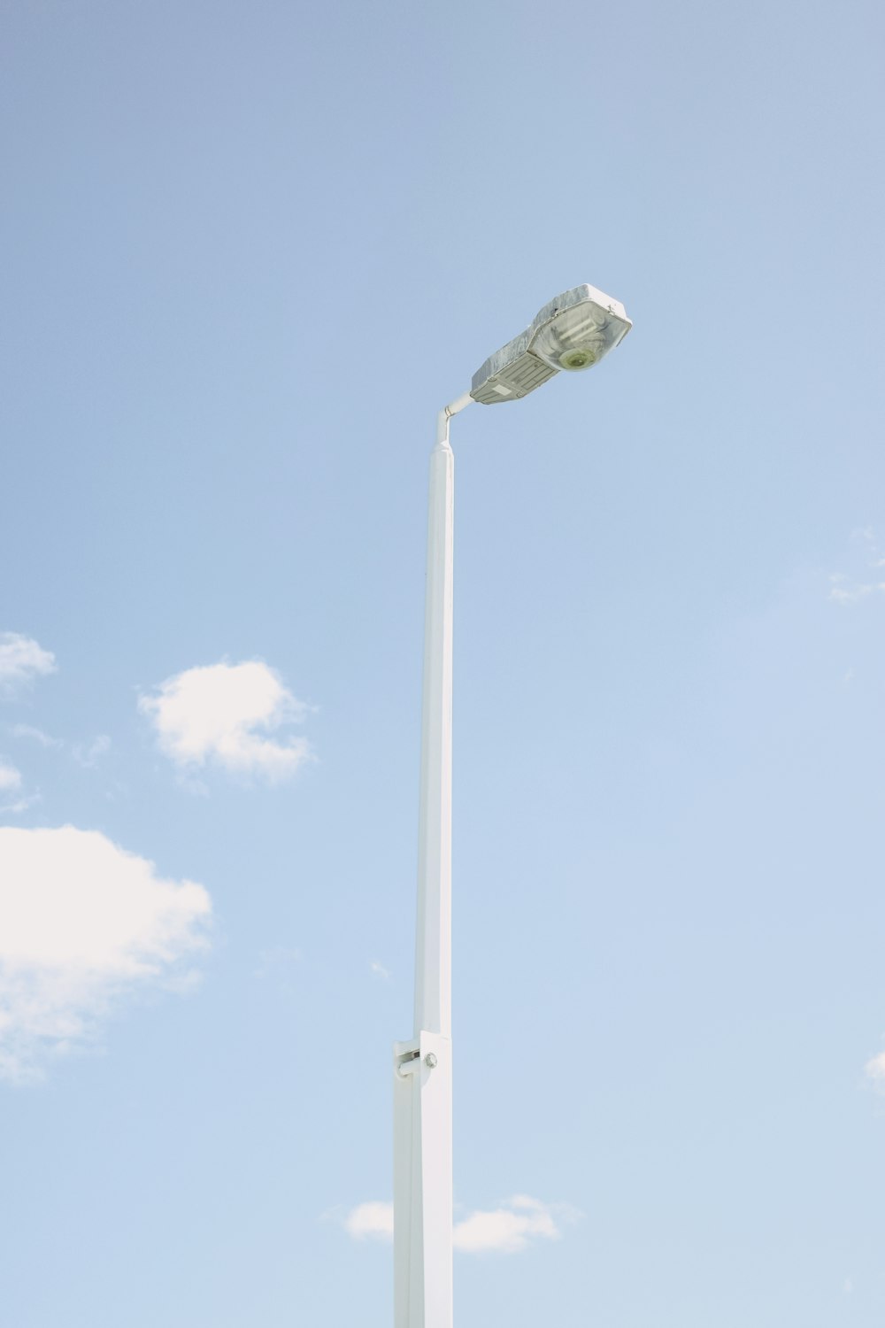 white and gray street light under blue sky during daytime