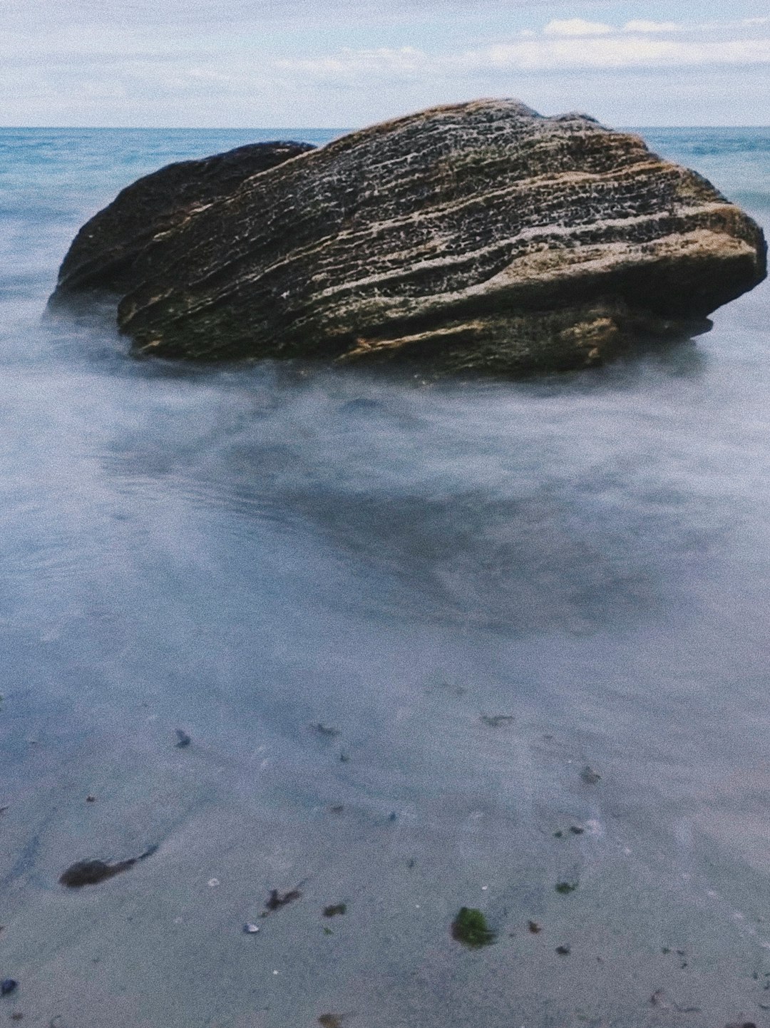 brown rock on gray sand