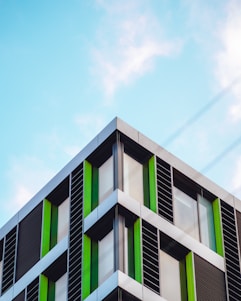 green and white concrete building under blue sky during daytime