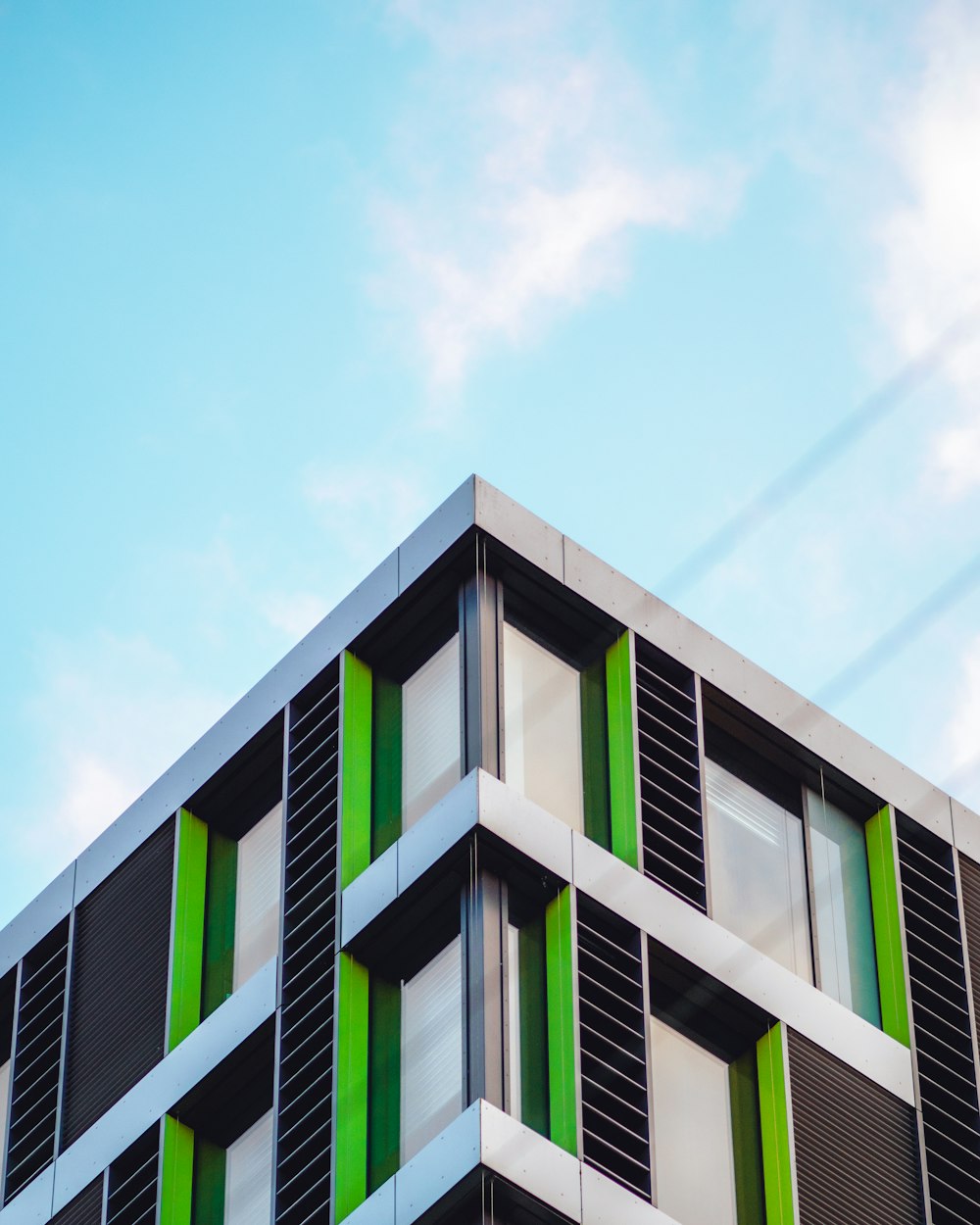 green and white concrete building under blue sky during daytime