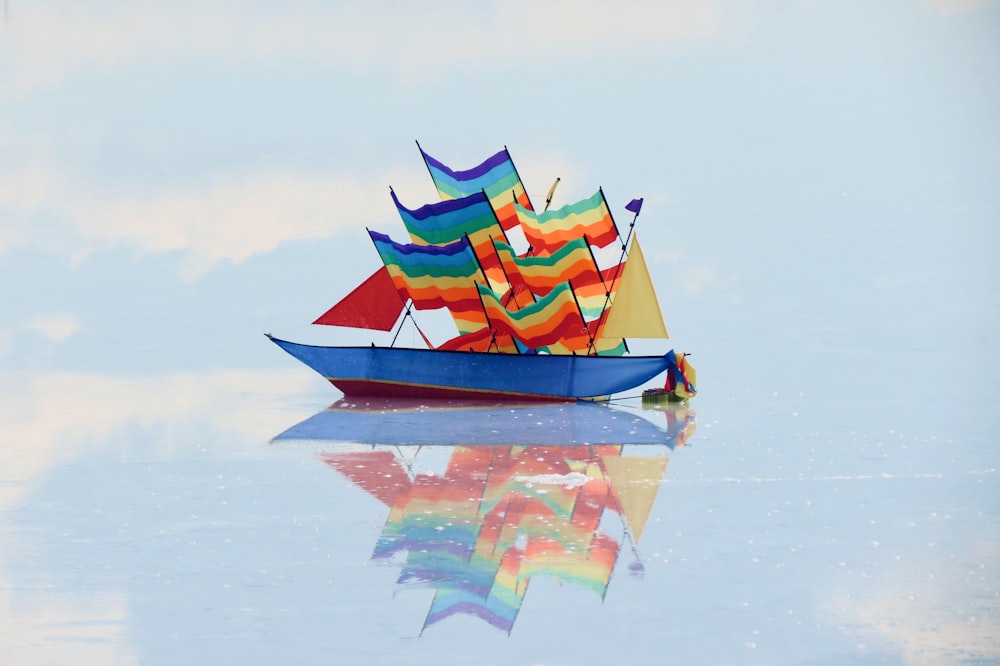 red and yellow boat on water