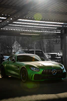 Wide shot of a neat UK garage with a car protected by Safehaven, sunlight streaming in.