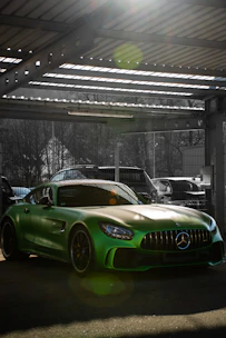 Shiny vehicle with freshly tinted windows reflecting sunlight in a modern garage.