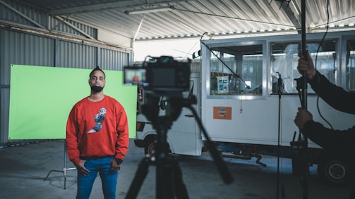 man in red sweater standing beside man in red sweater