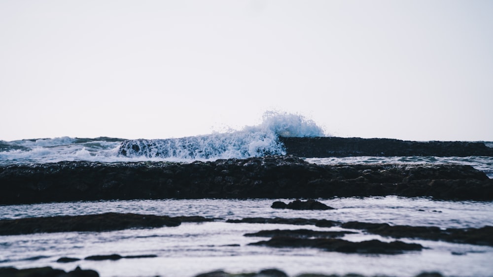 ocean waves crashing on shore during daytime