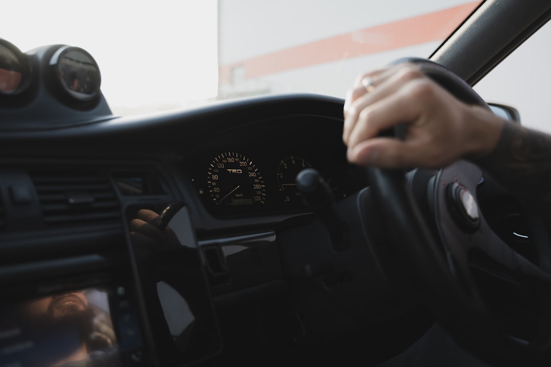 person in black long sleeve shirt driving car