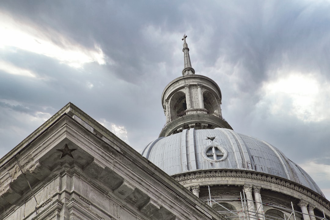 gray concrete building under white clouds during daytime