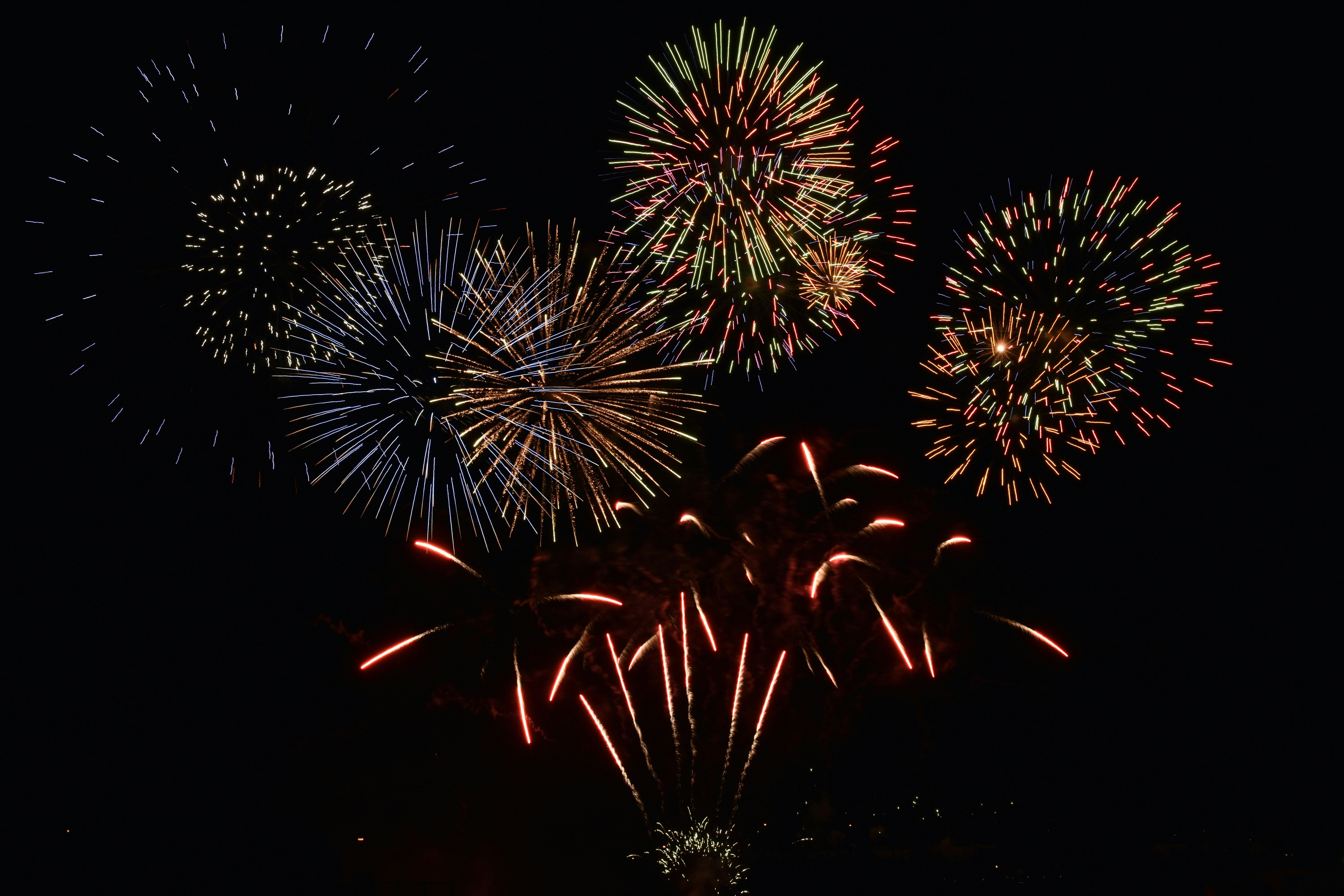red and white fireworks display during nighttime