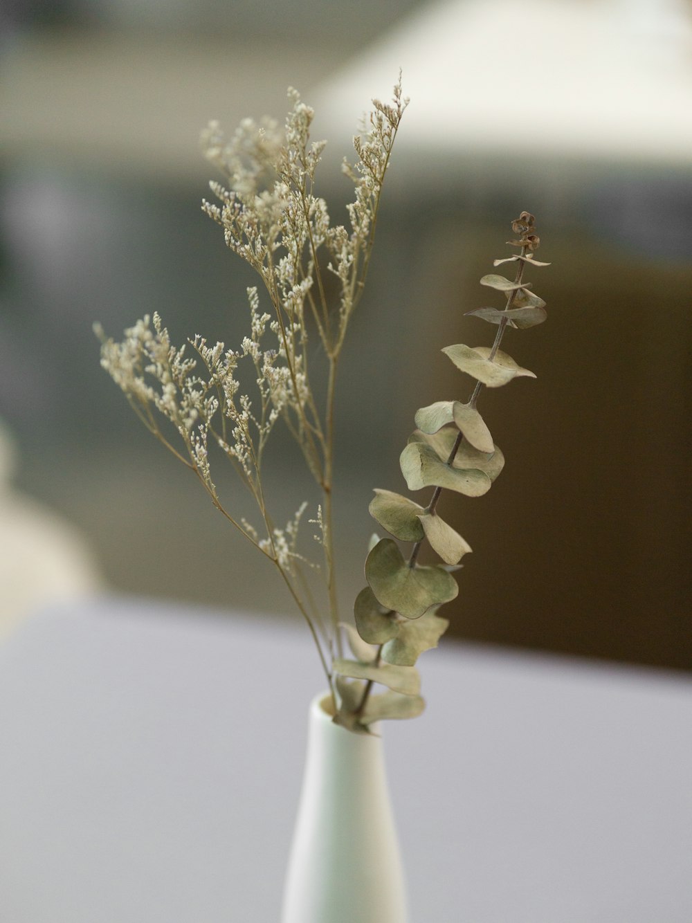 white flower in white ceramic vase