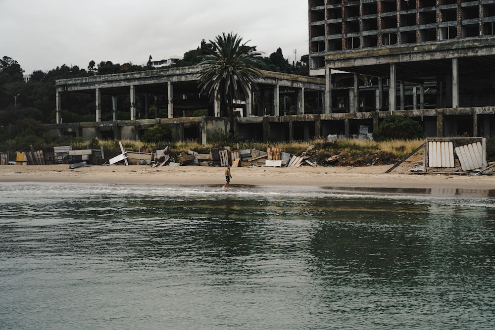 people walking on beach shore near building during daytime