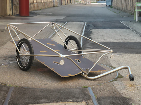 Rolling office cart with clean lines, wheels in motion on a hardwood floor.