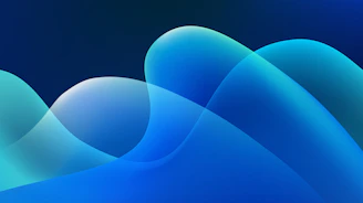 Abstract geometric shapes in teal and aqua softly glowing against a deep blue background.