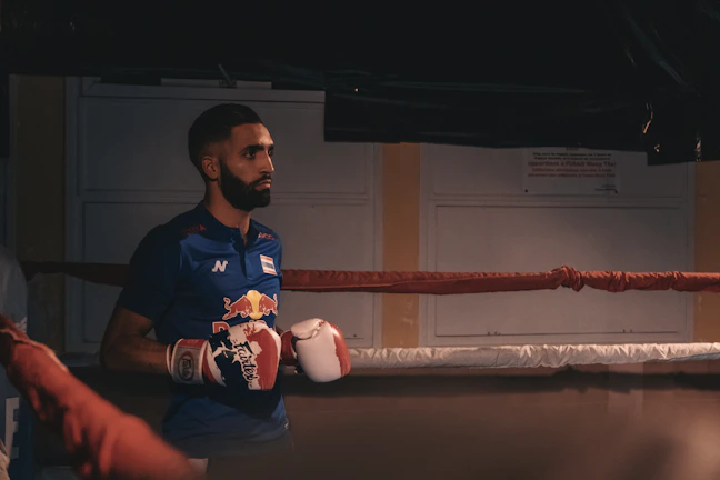 Close-up of a fighter's intense gaze under the arena lights.