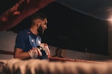 Close-up of a boxer throwing a punch in a dimly lit ring