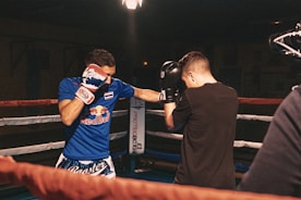 man in black t-shirt holding black dslr camera