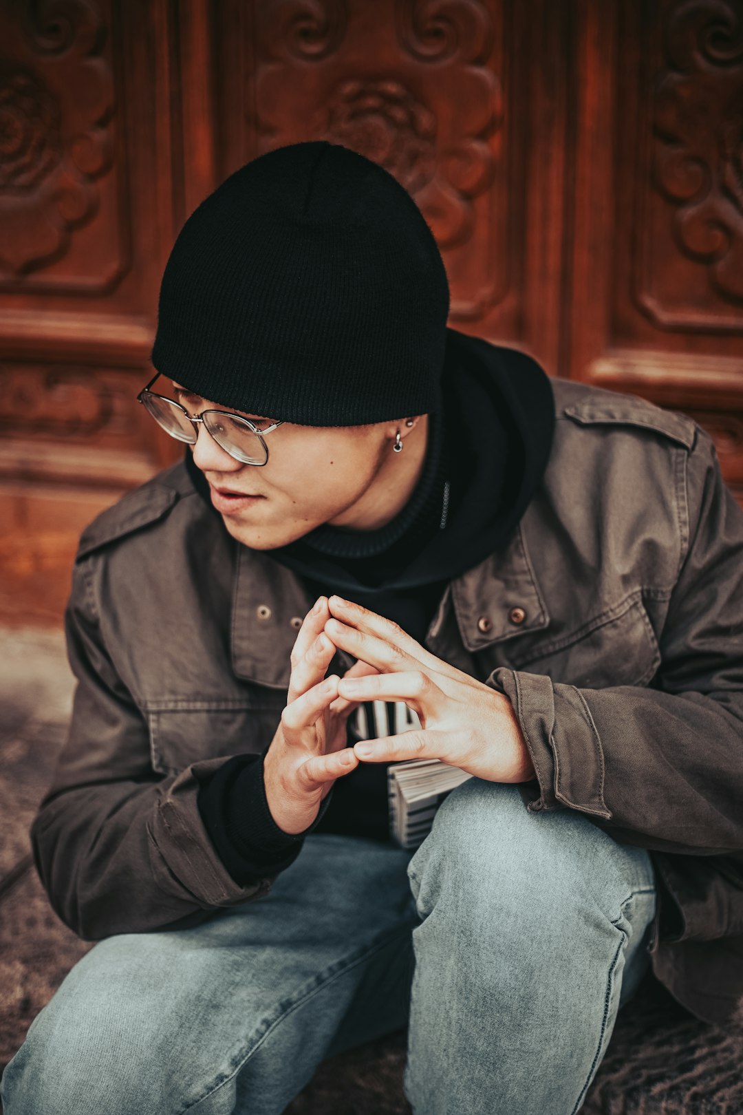 man in black knit cap and brown jacket