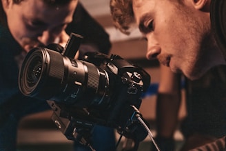 A customer testing a camera with a friendly staff member assisting.