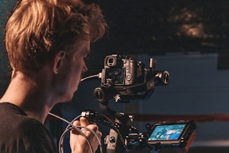 man in black shirt using video camera