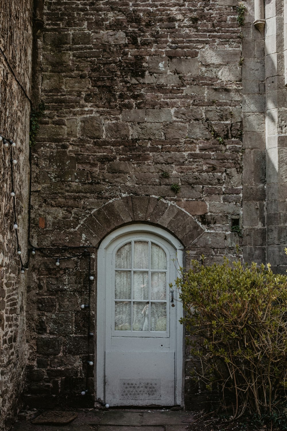 white wooden window frame on brown brick wall