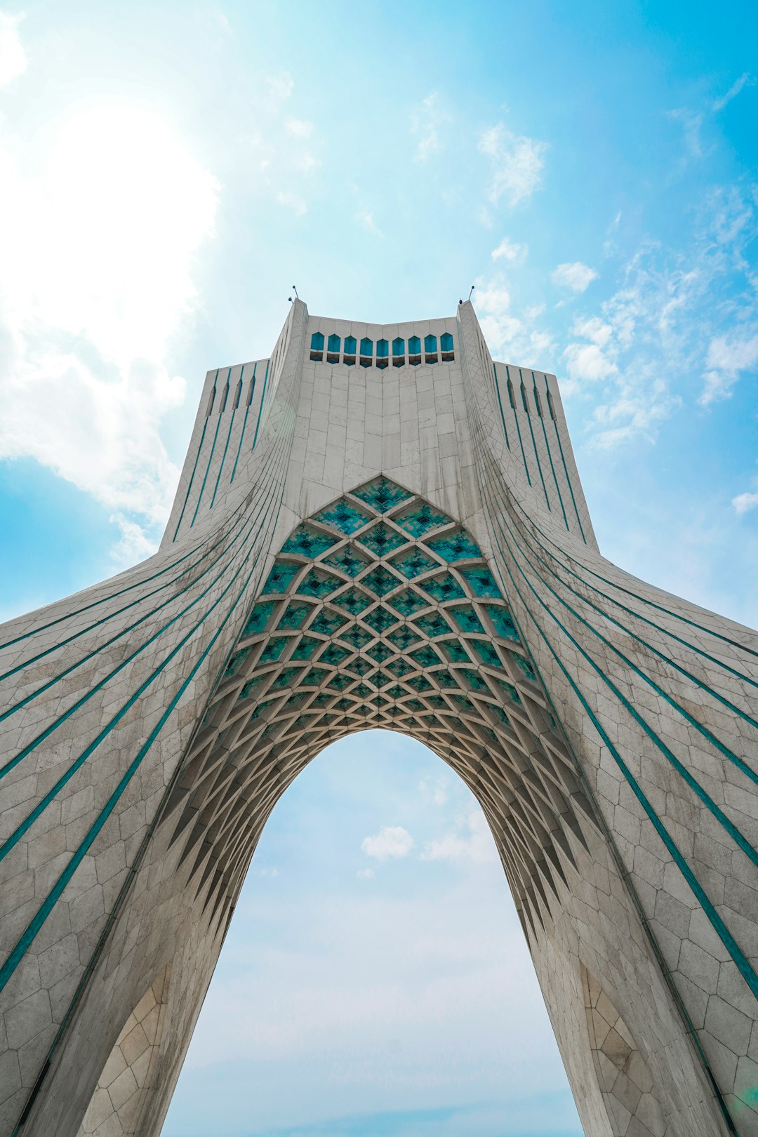 low angle photography of gray concrete building under blue sky during daytime