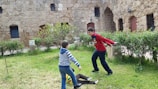 Children enjoying outdoor playtime in a safe, green courtyard.