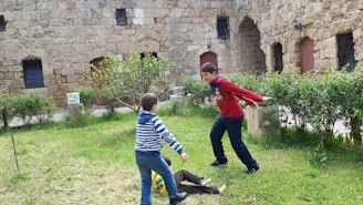 Children playing in a safe, green courtyard of a residential complex.