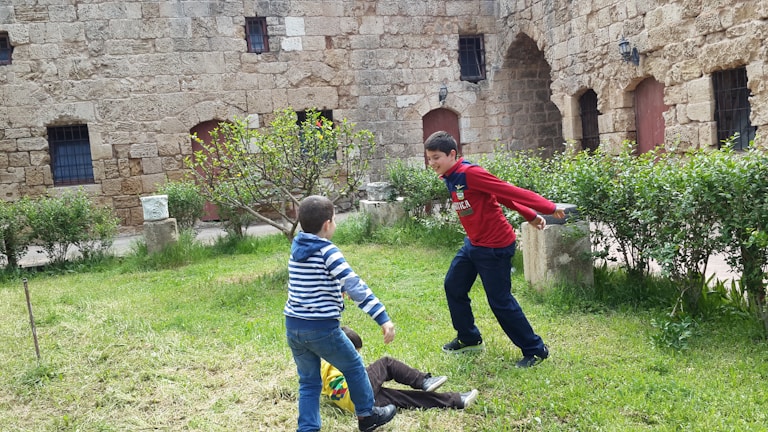 Children enjoying outdoor playtime in a safe, green courtyard.